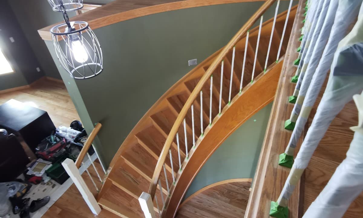 stained oak railing prior to being painted white - railing painting calgary